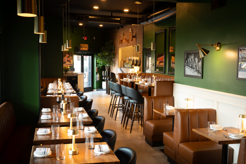 Green walls and pendant lighting in the Prose dining room