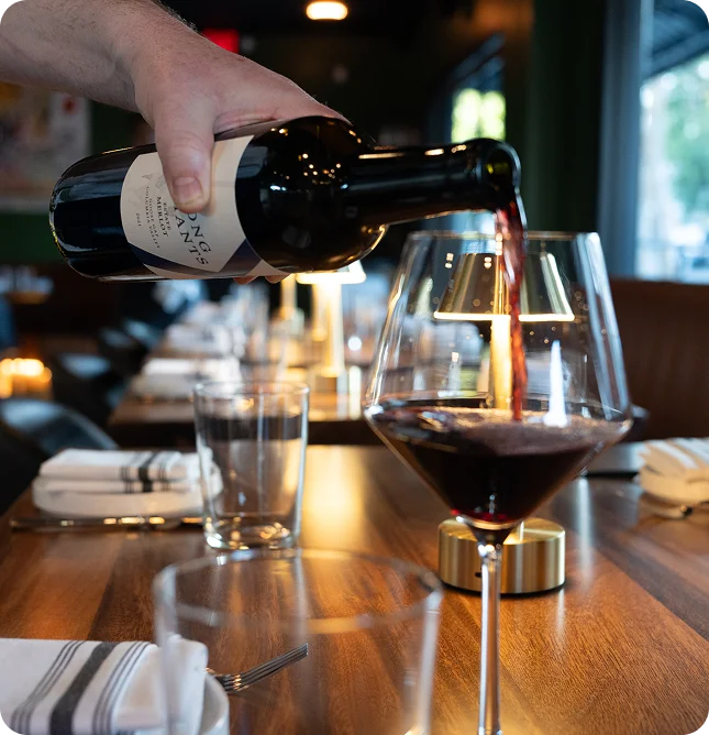 Pouring wine at a table at Prose Kitchen & Bar in Woodland Hills