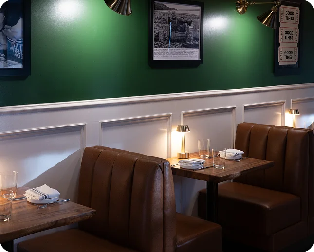 Leather booths and green walls in the dining room at Prose Kitchen & Bar