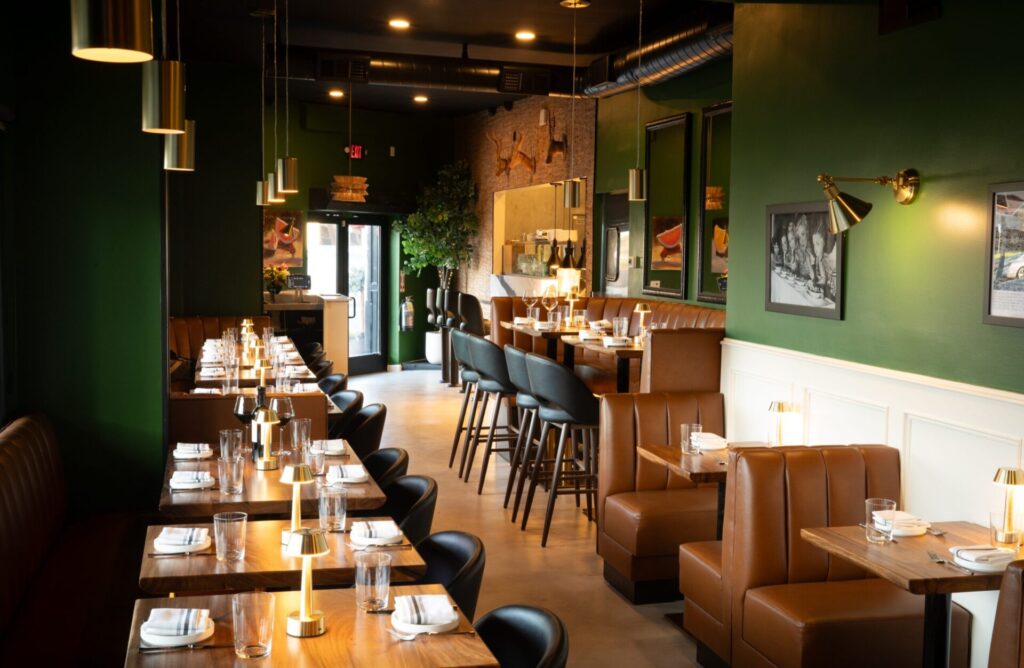 The green dining room at Prose Kitchen & Bar, set for dinner