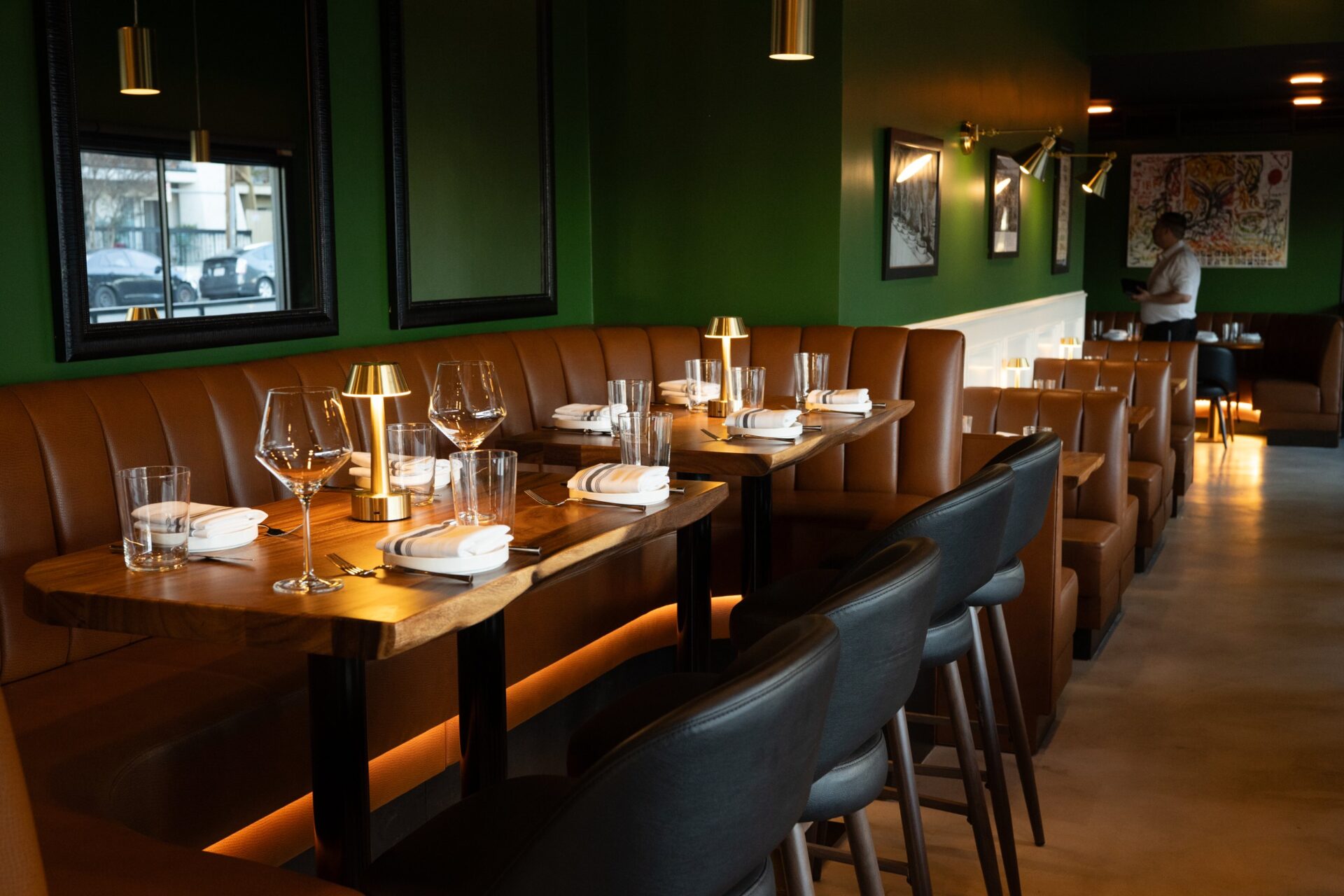 Banquette tables beneath brass pendants at Prose Kitchen & Bar