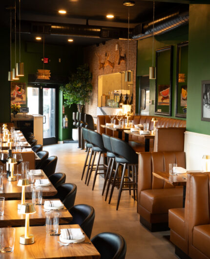 Green walls and pendant lighting in the Prose Kitchen & Bar dining room